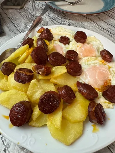 Huevos rotos with chorizo and potatoes, classic Spanish tapas