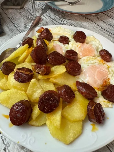 Huevos rotos with chorizo and potatoes, classic Spanish tapas