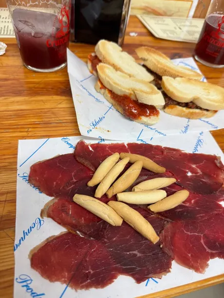 Iberian ham with breadsticks and montaditos at a Seville tapas bar